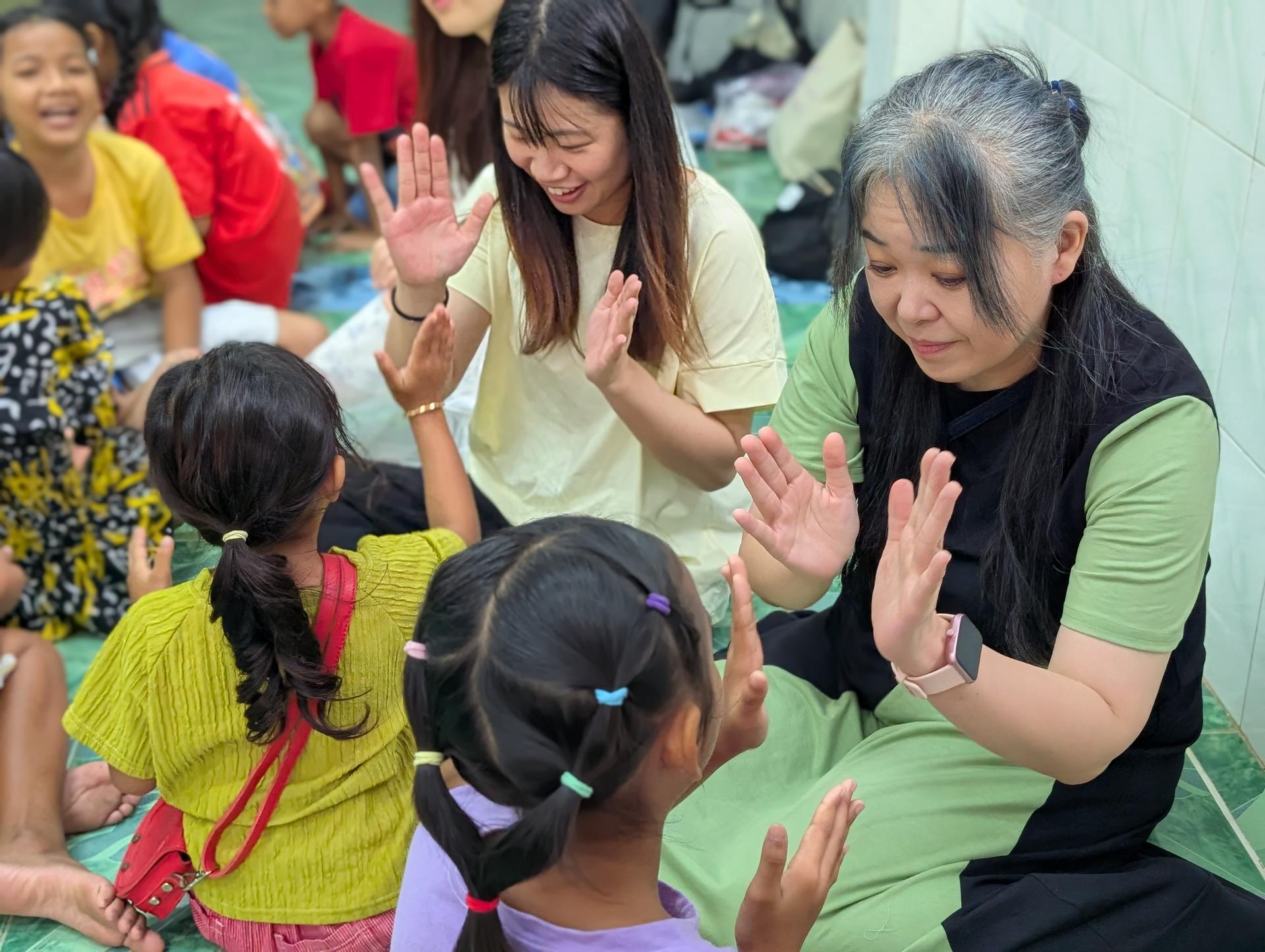 CBS students play with children in Cambodia