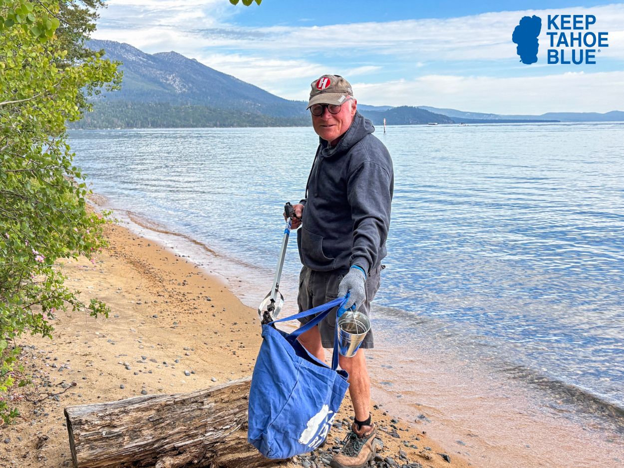 VOLUNTEER CLEANING UP NEAR SHORELINE