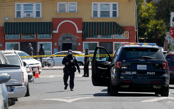 Oakland police investigate the scene of a homicide