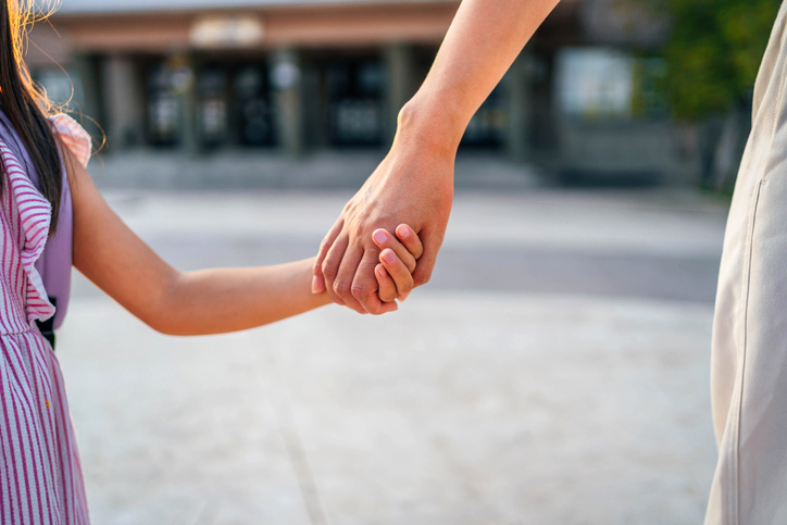 Mother and daughter holding hands