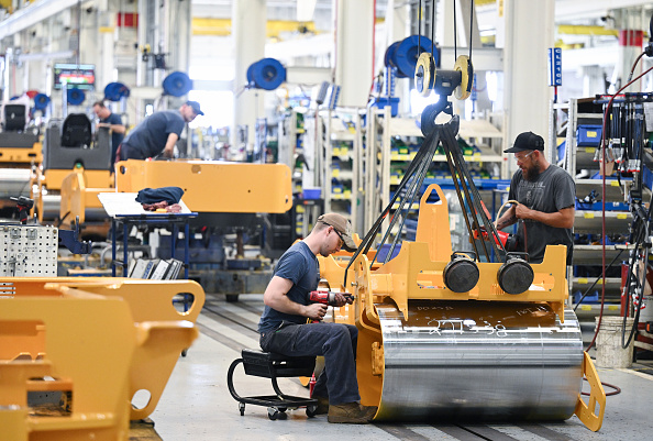Workers are seen on an assembly line for compactors at Volvo Construction Equipment plant on Thursday June 6, 2024 in Shippensburg, PA.