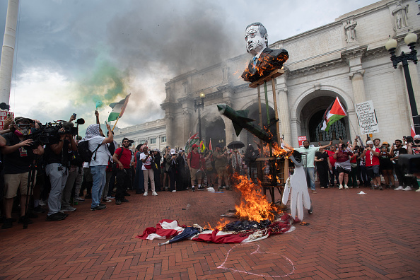 Protesters burn an American Flag outside of Union Station