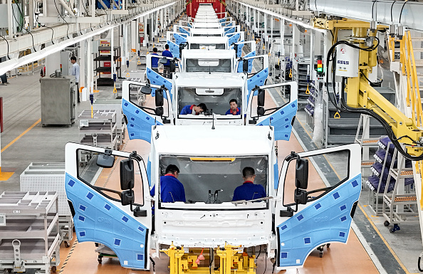 Workers work on an automobile production line at BYD Industrial Co LTD in Huai'an, China