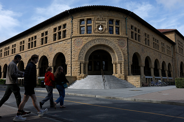 Pedestrians walk on the Stanford University campus.