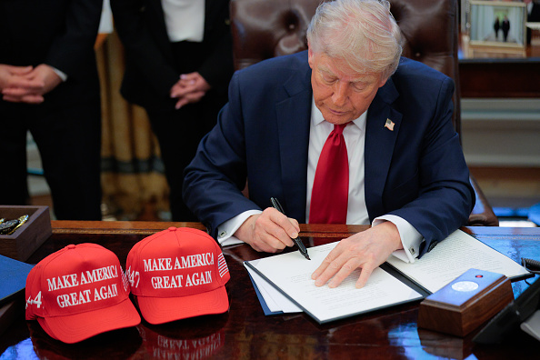 U.S. President Donald Trump signs an executive order in the Oval Office at the White House.