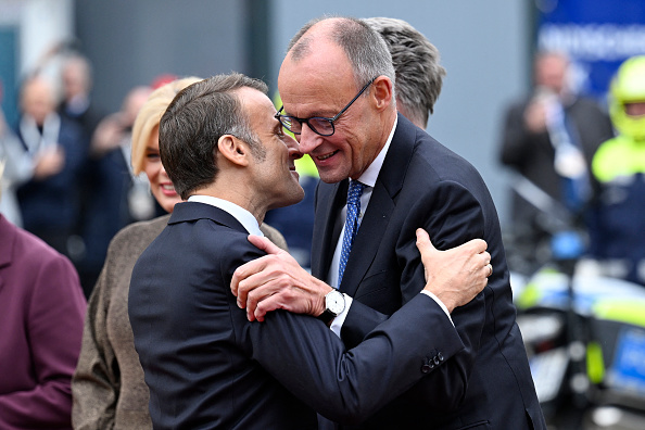 France's President Emmanuel Macron greets German Chancellor Friedrich Merz