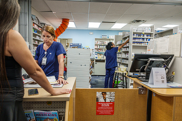 A pharmacist talking to customer