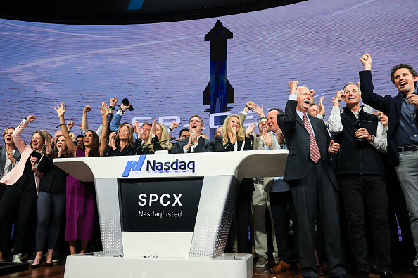 SpaceX executives and employees ring the opening bell at the Nasdaq MarketSite