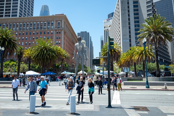 People walk through the Embarcadero neighborhood in San Francisco