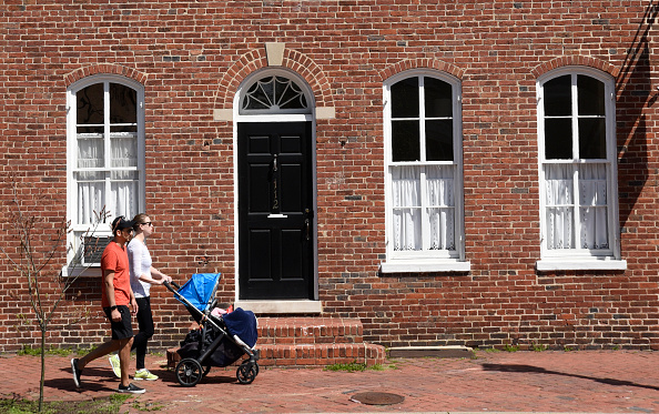 A couple pushes a stroller 