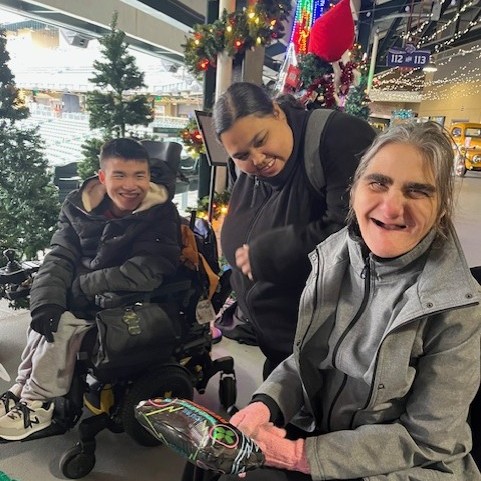 Winston, VIcki and Deb smile as they decorate our Via tree