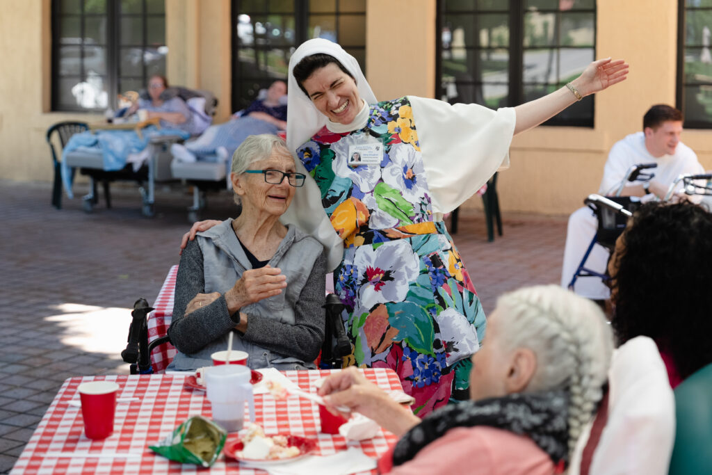 Nun laughing with elderly women